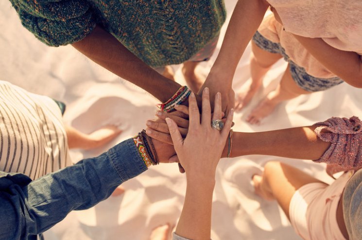 Diverse hands joined together in unity, faith put into action