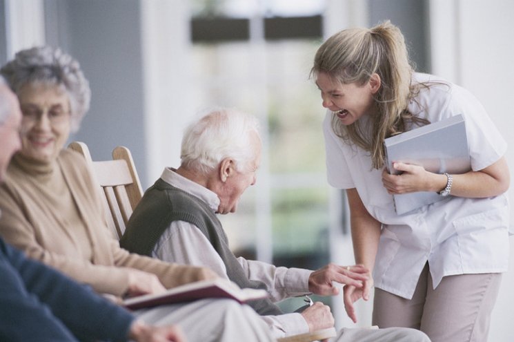 A Bedside Village advocate visiting with hospital and nursing home residents